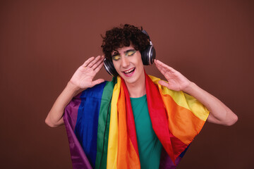 A young attractive guy listens to music on headphones.	