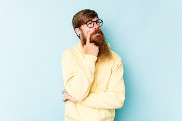 Young caucasian red-haired man isolated on blue background crying, unhappy with something, agony and confusion concept.