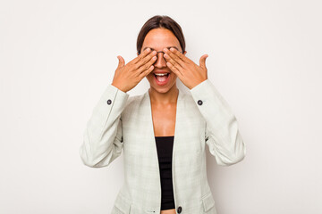 Young hispanic woman isolated on white background covers eyes with hands, smiles broadly waiting for a surprise.