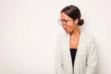 Young hispanic woman isolated on white background shouting very angry, rage concept, frustrated.