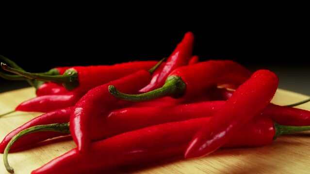 On wood plank Ripe red long hot chili peppers are the world's number one culinary delight and cash crop in New Mexico, USA, Vietnam, Thailand, Asia. They are a delightful part of world cuisine.