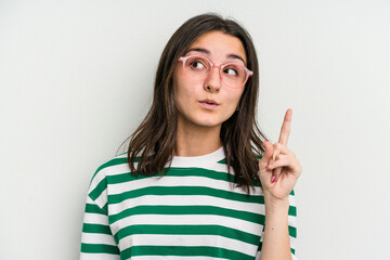 Young caucasian woman wearing a glasses isolated on blue background having some great idea, concept of creativity.