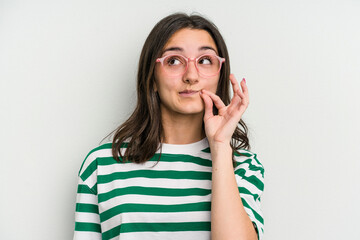 Young caucasian woman wearing a glasses isolated on blue background with fingers on lips keeping a secret.