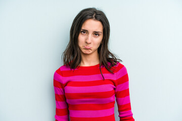 Fototapeta premium Young caucasian woman isolated on blue background sad, serious face, feeling miserable and displeased.