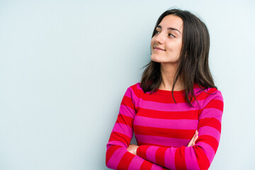 Fototapeta premium Young caucasian woman isolated on blue background smiling confident with crossed arms.