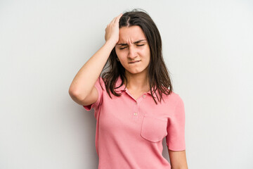 Young caucasian woman isolated on white background forgetting something, slapping forehead with palm and closing eyes.