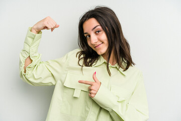 Young caucasian woman isolated on white background showing strength gesture with arms, symbol of feminine power