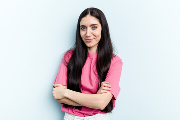 Young caucasian woman isolated on blue background happy, smiling and cheerful.