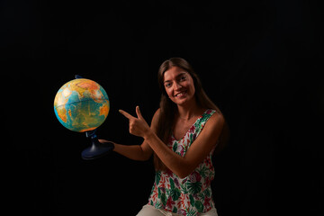 young woman observes the sphere of the world illuminated from within