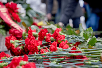Carnations lie on the granite of the monument to Lenin. Anniversary of the revolution of 1917.