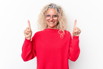 Middle age caucasian woman isolated on white background indicates with both fore fingers up showing...