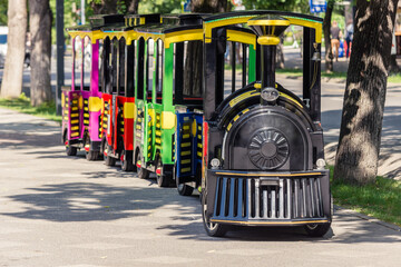 Amusement park train for kids with wheels to be driven on the road or on the sidewalk