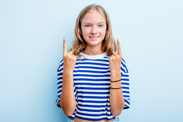Caucasian teen girl isolated on blue background indicates with both fore fingers up showing a blank...