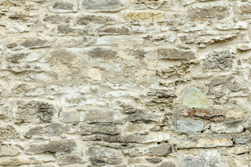 Old gray stone wall. Stone background from gray old stones.