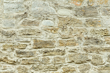 Solid yellow and beige stone wall. Stone background.