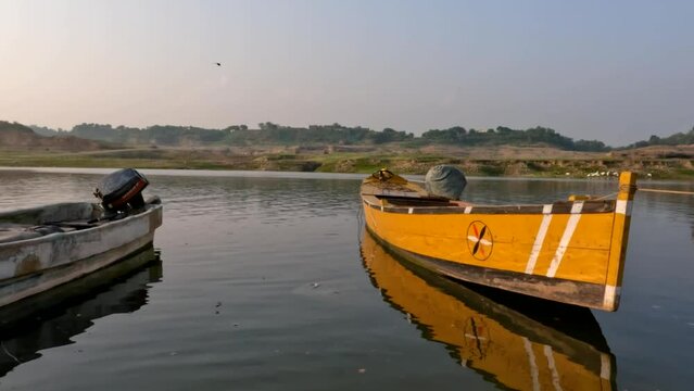 Panning shot of wooden boats in lake or river shore, Pakistani or Indian or South Asian dam video shot
