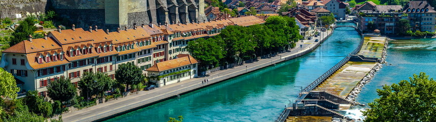 View on the Kirchenfeld Bridge over the Aare River that connects Casinoplatz with Helvetiaplatz in the Kirchenfeld district. The historic residential houses built along the riverbank.