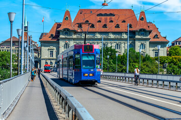 BERN, SWITZERLAND - August 2nd 2022: The blue tram on the Kirchenfeld Bridge over the Aare River.