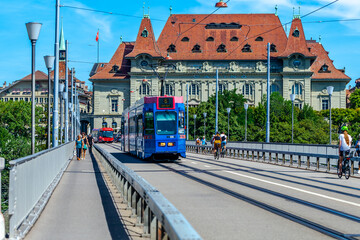 BERN, SWITZERLAND - August 2nd 2022: The blue tram on the Kirchenfeld Bridge over the Aare River.
