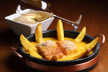 Salmon in passion fruit sauce with potatoes. Gastronomy.