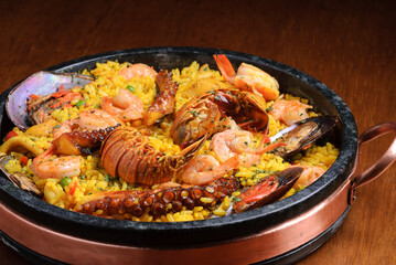 Traditional spanish paella with seafood on wooden table. Spanish cuisine.