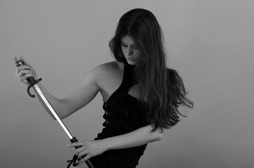 Woman holding vintage bayonet-knife in black and white