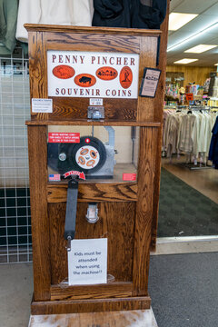 West Yellowstone, Montana - July 17, 2022: A Penny Pincher Souvenir Coin Press Machine Outside Of A Yellowstone National Park Gift Shop