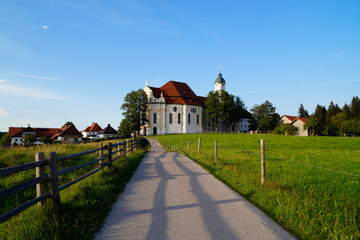 The Pilgrimage Church of Wies (German: Wieskirche) is an oval rococo church in the Bavarian Alps on a sunny day in August (Steingaden, Weilheim-Schongau district, Bavaria, Germany)