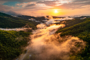 Mountains. Colorful sunset. Panorama of Great Smoky Mountains North Carolina. Scenic aerial view. Fly over clouds or fog. Green forest. Green hill. Hiking tourism. Good for travel agency or posters.