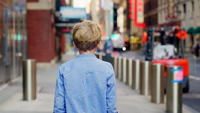 Blond Boy In Blue Walking Along New York City Street
