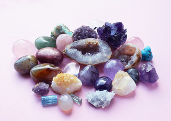 Beautiful amethyst crystals, round rose quartz stone and bostwana agate on a wooden background. Magic amulets.