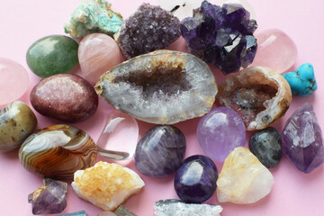 Beautiful amethyst crystals, round rose quartz stone and bostwana agate on a wooden background....