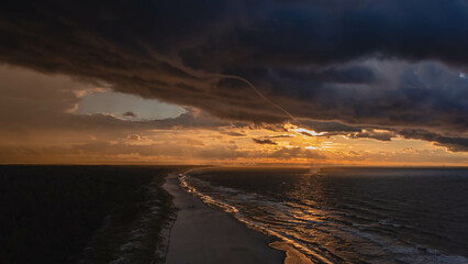 Obraz premium A drone view of a small tornado and an amazing sunset in Sobieszewo. Gdansk, Poland.