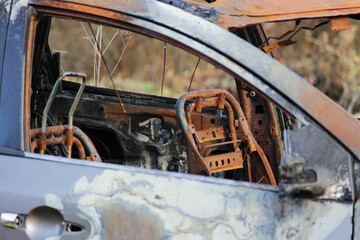 burnt car, on the forest, rusty metal