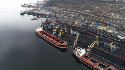 Port filled with coal, waiting for ships to start loading. Murmansk, Russia. Drone view