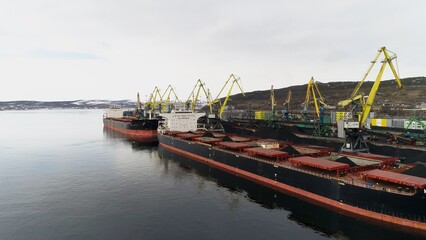 Fototapeta na wymiar View of Murmansk and part of seaport intended for loading coal. View from camera on drone from sea side
