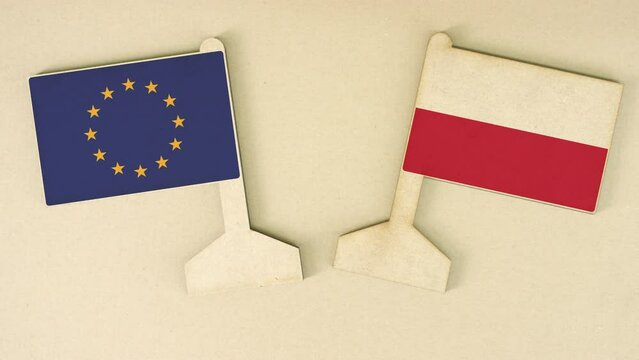 Flags of the European Union and Poland made of recycled paper on the cardboard table
