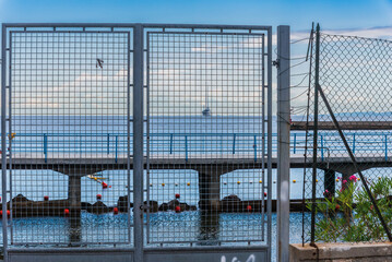 chicken wire fence in the harbor of trieste, italy