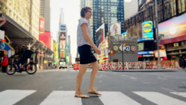 Woman Using Pedestrian Crossing In New York City
