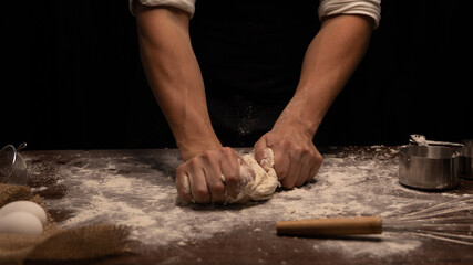 person kneading dough on the table