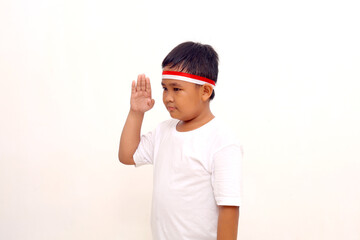 Asian boy standing with respect or salute gesture. Indonesian independence day concept