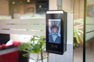 Access control facial recognition system. A man faces scanning the modern technology security ....