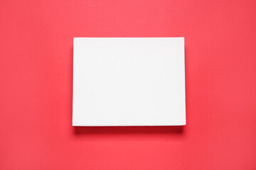 Blank canvas on red background, top view. Space for design