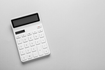 White calculator on light background, top view. Space for text