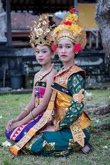 Two beautiful girls in the temple. Dressed in old traditional costume.