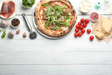 Tasty pizza with meat and arugula on white wooden table, flat lay. Space for text
