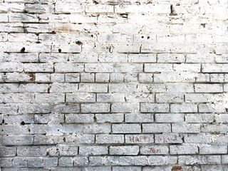 Weathered bricks painted white on a sunny day with shadows
