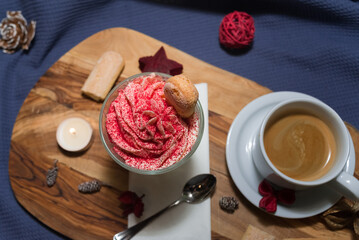 Dessert of whipped cream, savoyardi cookies and raspberry sprinkles with a cup of hot espresso coffee without milk
