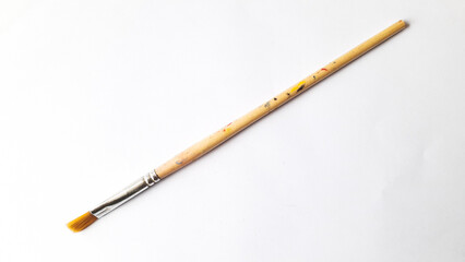 Top view of a variety of artist brushes on a white background with copy space for text. Creative postcard.