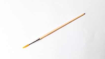 Top view of a variety of artist brushes on a white background with copy space for text. Creative postcard.